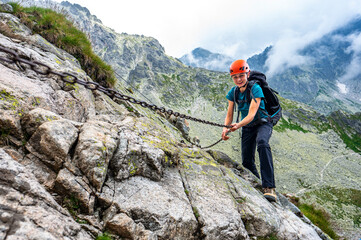 Woman climbing in the mountains.