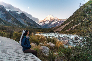 Wall Mural - Hooker valley track with female tourist enjoying on trail and mount cook at New Zealand