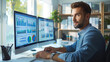 © GoodandEvil - Businessman working on dual monitors with charts.