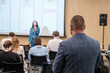 © Anton Gvozdikov - Business conference showing professional audience attentively listening to speaker's presentation in a corporate setting