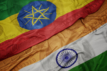 Wall Mural - waving colorful flag of india and national flag of ethiopia on the dollar money background. finance concept.