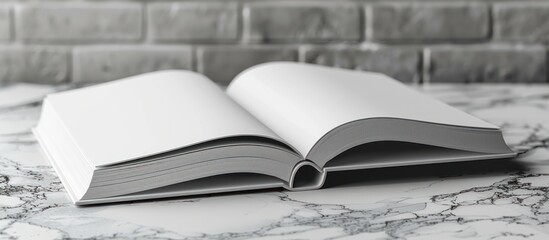 Poster - Blank Book Open on Marble Surface with Brick Wall Background