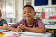 © Rido - Portrait of african american child sitting at desk at elemetary school