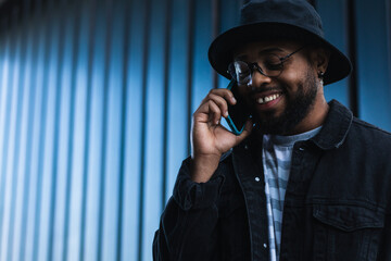 happy black man talking on mobile phone and laughing