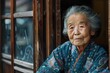 © martgraphy - Elderly Woman in Traditional Attire by Window
