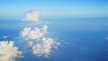 Wall Mural - aerial view of white large cloud, from airplane window with blue sky