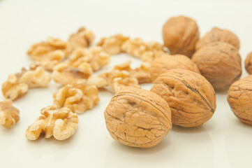 Walnuts in shell and peel nuts on white background