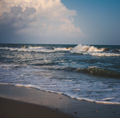 Wall Mural - Sandy beach, colorful sky slightly cloudy, sea waves