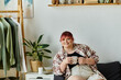 © Bliss - A woman with pink hair enjoys a cup of coffee at home.