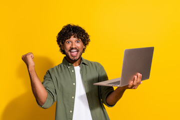 Sticker - Photo of indian guy curly haired confident senior level it specialist in khaki shirt finally found a job isolated on yellow color background