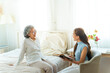 © CandyRetriever  - Happy Asian senior mature woman reading a book with caregiver in bedroom. Happy elderly woman enjoy indoor activity lifestyle at home. Senior people mental health care, nursing and caregiving concept.