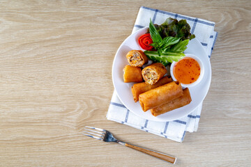 Wall Mural - Fried spring rolls on the wooden table