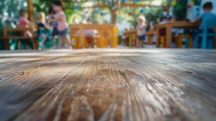 Poster - A close-up of a weathered wooden tabletop with a blurred background of children playing in a colorful outdoor space.