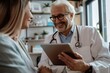 © Sourav Mittal - Portrait of a smiling doctor with a digital tablet talking to a senior woman during a medical checkup at a clinic, photographed with a Sony Alpha a7 III, featuring white and beige colors, the photo ta