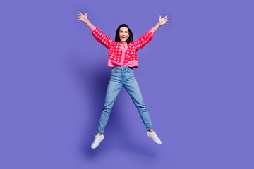 Poster - Full length photo of adorable lovely girl wear pink cardigan jumping high empty space isolated purple color background