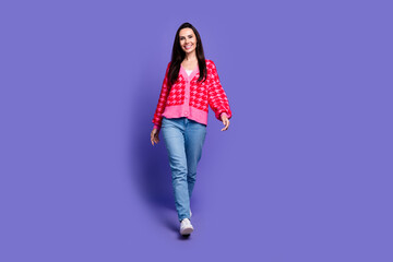 Sticker - Full length photo of cheerful pretty lady dressed pink cardigan walking empty space isolated violet color background