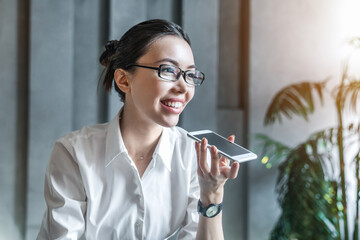 Smiling woman in eyeglasses having business phone conversation. Businesswoman female entrepreneur talking on mobile phone with partners. Concept of client and customer service