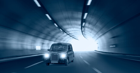 Wall Mural - Highway road tunnel with Typical black british taxi cab