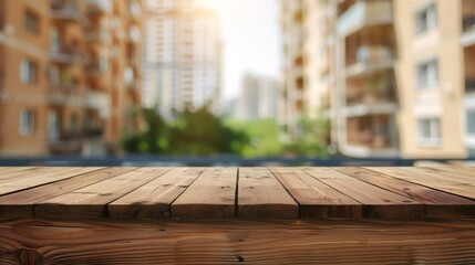 Poster - A close-up of a wooden tabletop with a blurry background of city buildings and greenery.