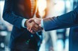© Worrapol - Handshake Deal: Two businessmen in formal attire shake hands, signifying a successful partnership and agreement.  The image captures the essence of collaboration, trust, and mutual benefit, with a war