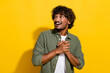© deagreez - Portrait of young hispanic guy in khaki shirt arms together having interesting promo offer look mockup isolated on yellow color background