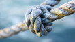 © Bonsales - Close up of a knot in a marine rope, showing its detailed texture and weathered surface, strength and durability concept