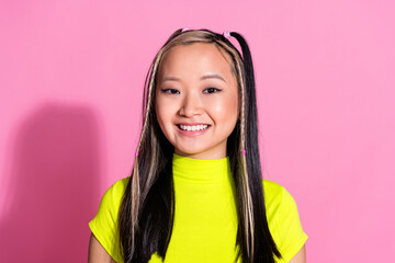 Wall Mural - Photo of optimistic adorable chinese girl with dyed hairstyle dressed yellow t-shirt toothy smiling isolated on pink color background