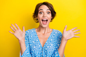 Poster - Photo of overjoyed crazy girl with bob hair dressed print blouse hold palms up scream open mouth isolated on yellow color background