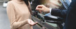 © Pormezz - transportation rental automotive business concept. Close up hands of rental auto agent giving car remote key to client to travel sightseeing.