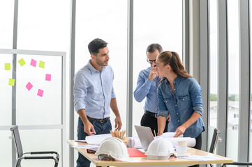 Construction engineer and architect check plan working with the blueprint on office worker conference site. Engineers team meeting for architectural project. Construction Concept.