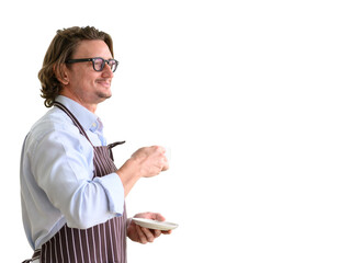 Portrait of happy senior man wearing glasses and denim apron spending and holding cup of hot coffee enjoying isolated on white background.