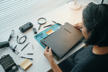 Wall Mural - High angle view of master repairing computer working in service