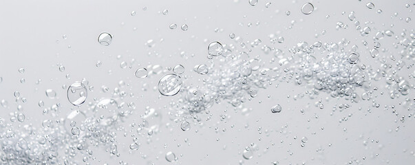 A cluster of small bubbles rising diagonally across a blank white background, creating a sense of motion and lightness.