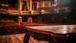 © Lull - Theater stage table with empty seats. A wooden table sits on a theater stage with empty seats in the background.  The soft lighting and warm tones create a sense of anticipation.