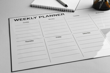 Wall Mural - Timetable. Planner, notebook and pen on grey table, closeup