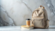 © Julia Zarubina - school backpack, books, cup of coffee on marble grey background, education, study, college, student, bag, September 1, space for text, knowledge, travel, stylish, beige, pastel, tea, drink, wall