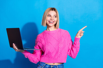 Poster - Portrait of nice young woman direct finger empty space wear pink sweater isolated on blue color background