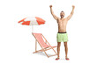 © Ljupco Smokovski - Beach chair and an excited man in a swimming shorts raising arms