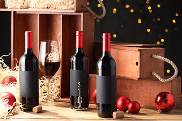 Wall Mural - Bottles of wine, glass, wooden boxes, corks and red Christmas balls on table