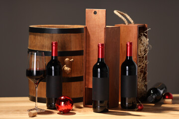 Wall Mural - Bottles of wine, glass, wooden gift boxes, barrel corks and red Christmas balls on table