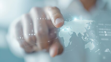 Wall Mural - A hand is pointing at a globe on a computer screen