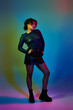 © LIGHTFIELD STUDIOS - A beautiful African American woman poses confidently in a short skirt and boots.