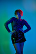 © LIGHTFIELD STUDIOS - Vibrant backdrop showcases African American woman posing gracefully in a short skirt.