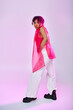 © LIGHTFIELD STUDIOS - A beautiful African American woman poses actively in a pink top and white pants against a vibrant backdrop.