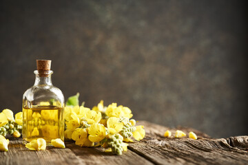 Wall Mural - A bottle of herbal tincture with fresh mullein or Verbascum densiflorum flowers on a rustic table with copy space