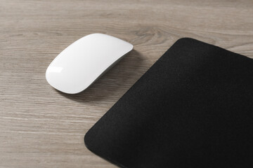 Wall Mural - Wireless mouse and mousepad on wooden table