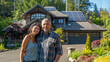 © Den b+f - couple in front of house in garden, solar panels