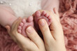 © Vad-Len - Mother is doing massage on her baby foot. Closeup baby feet in mother hands. Prevention of flat feet, development, muscle tone, dysplasia. Family, love, care, and health concepts. Studio macro.