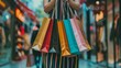 © Maria Mikhaylichenko - Colorful shopping bags held by a shopper in a bustling urban retail district, capturing the excitement of a successful shopping spree and consumer culture.