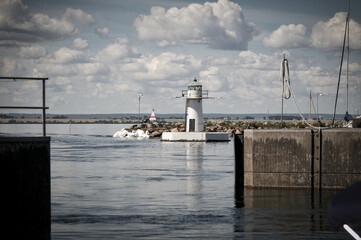 Wall Mural - A lighthouse by a lake during summer